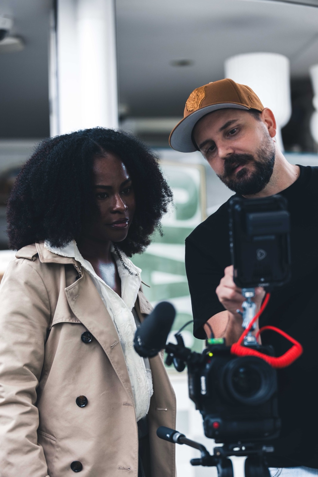 Demetri Conias of Bris.Social reviewing footage on a cinema camera with a model during a Brisbane content shoot.