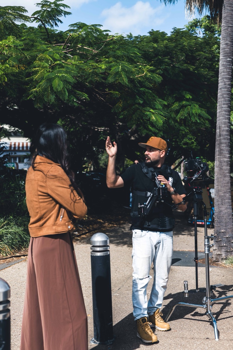 Demetri Conias of Bris.Social directing a model on location during a Brisbane content shoot.