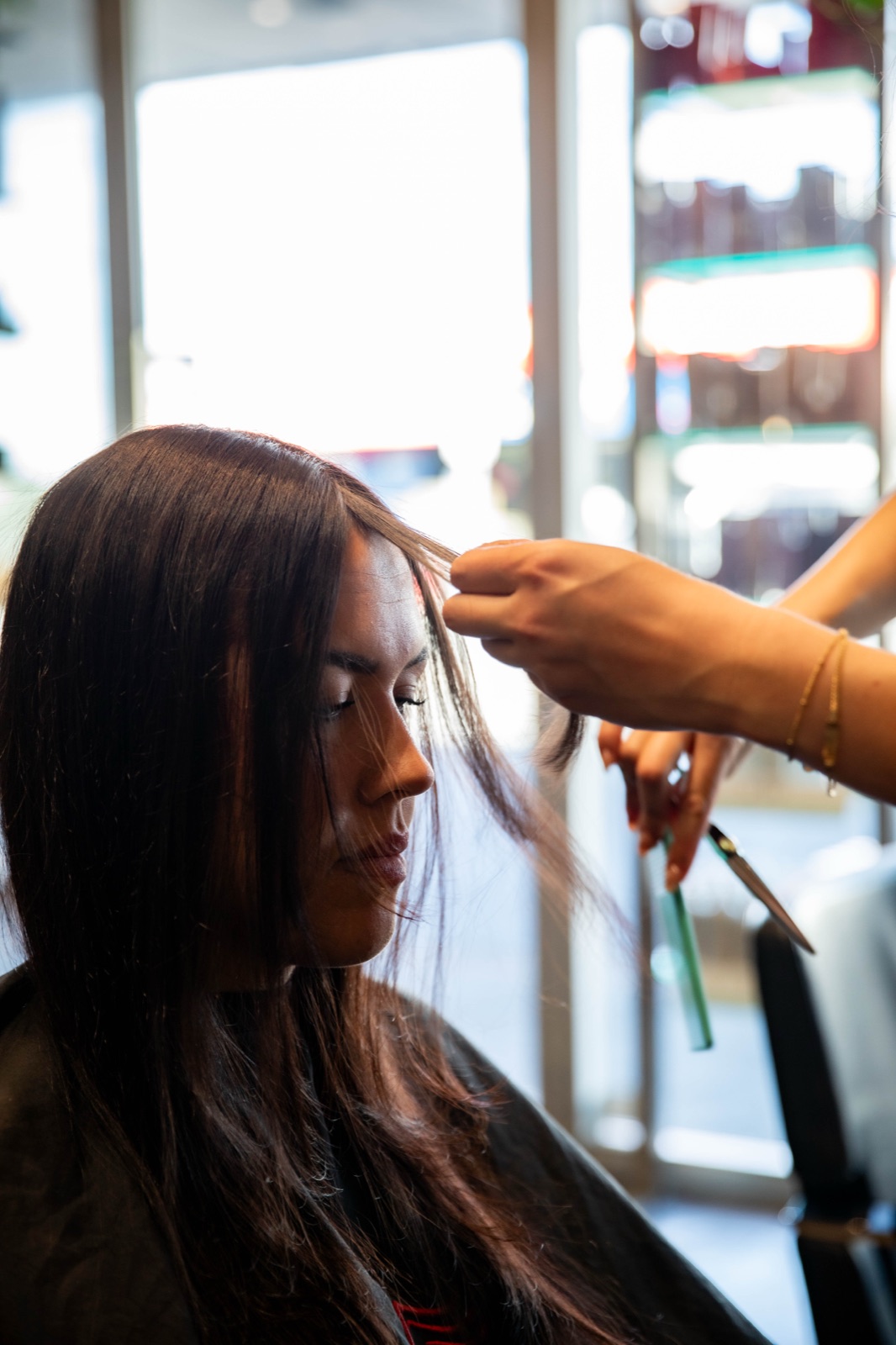 Hair by the Collective stylist combing a client's hair during a Bris.Social monthly retainer shoot in the Brisbane salon.